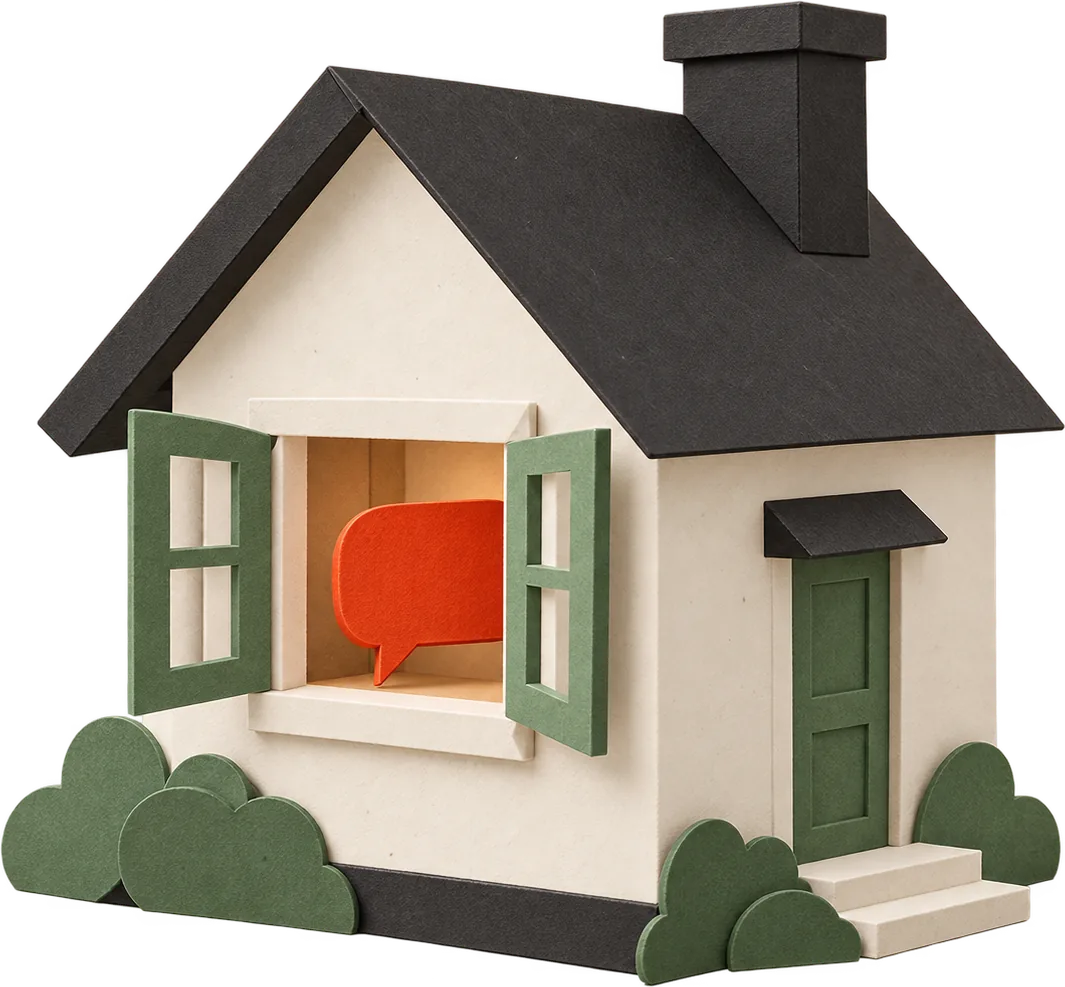 A small paper house with a red speech bubble safe inside its window